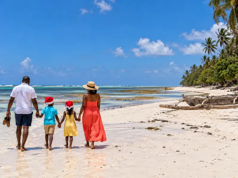 Family on a Christmas Mombasa package walking on Bamburi Beach
